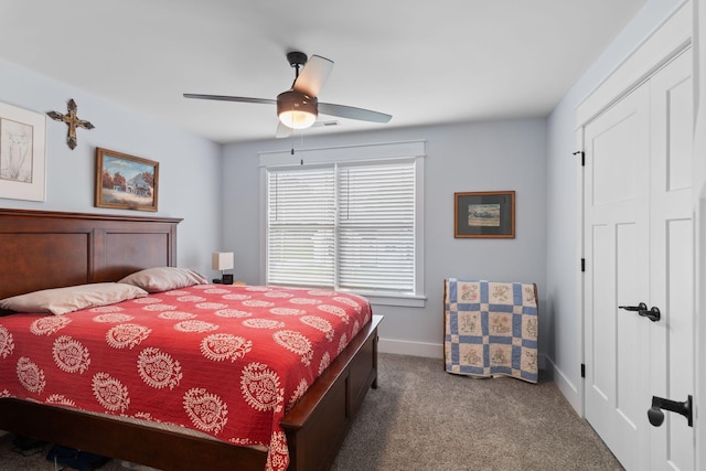 bedroom featuring baseboards, a ceiling fan, a closet, and carpet