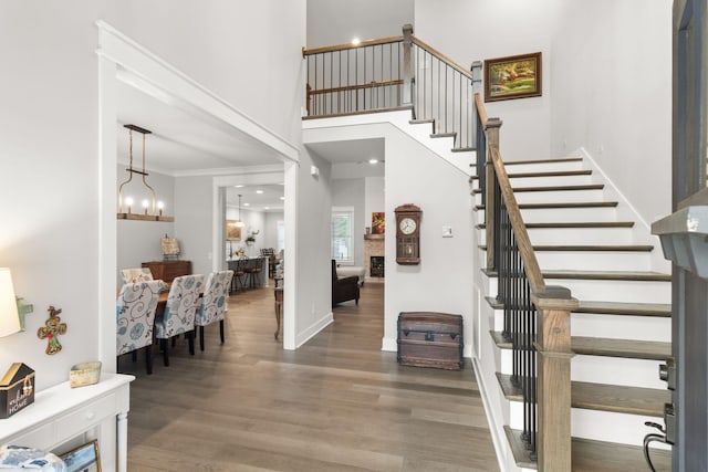 entrance foyer featuring stairway, wood finished floors, and crown molding