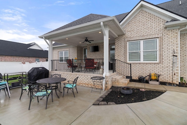 view of patio featuring a ceiling fan, outdoor dining area, grilling area, and fence