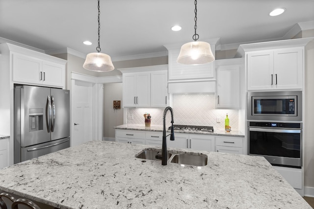 kitchen with a sink, tasteful backsplash, white cabinetry, ornamental molding, and appliances with stainless steel finishes