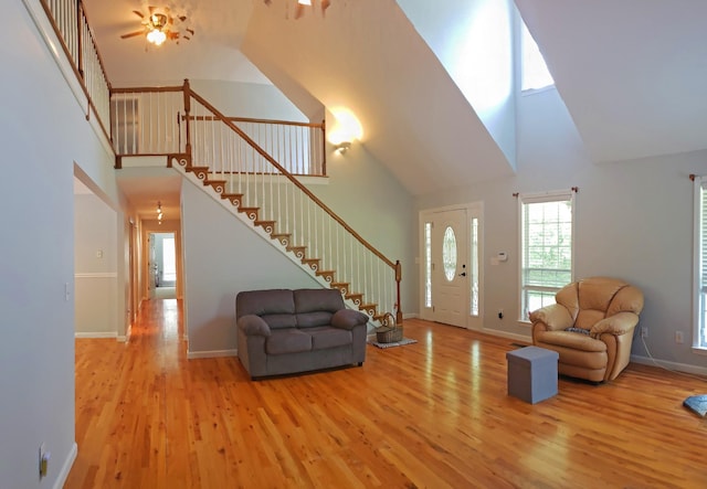 547 Grindstone Hollow Rd, Dickson, TN 37055 - living area with high vaulted ceiling, wood finished floors, stairway, ceiling fan, and baseboards