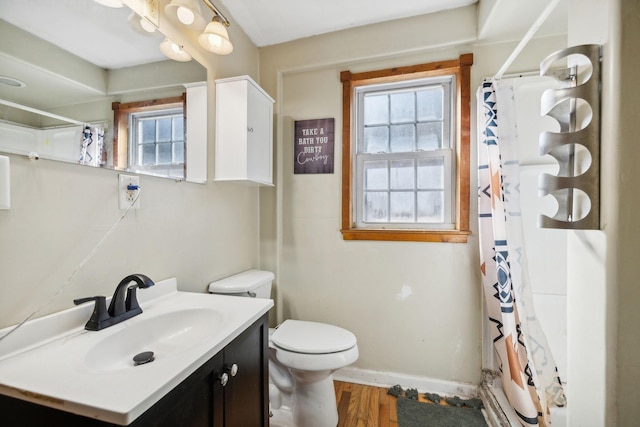 full bathroom featuring curtained shower, a healthy amount of sunlight, and toilet