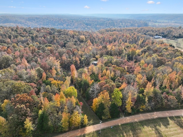 drone / aerial view with a wooded view