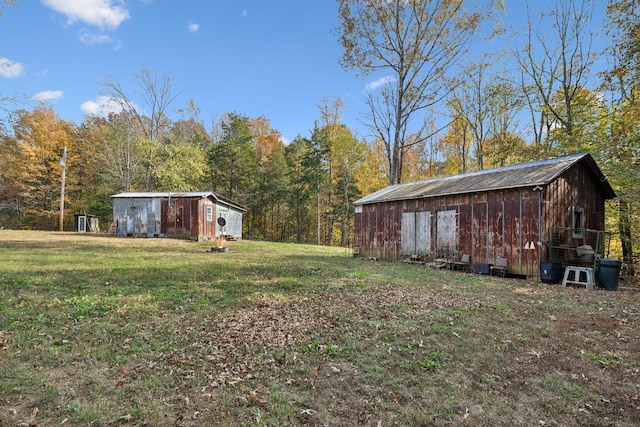 view of yard with a forest view and an outbuilding