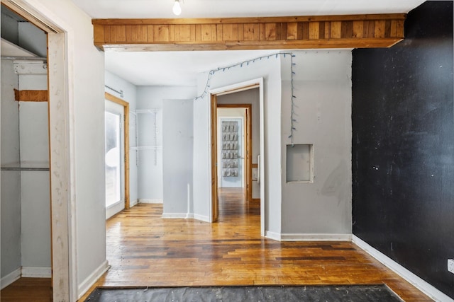 empty room with wood finished floors and baseboards