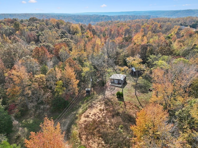 drone / aerial view with a wooded view