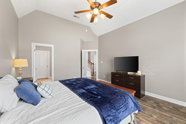 bedroom featuring high vaulted ceiling, a ceiling fan, visible vents, baseboards, and wood finished floors