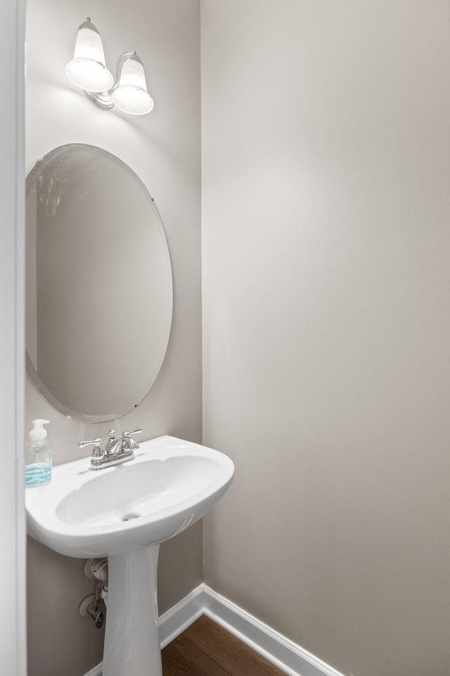 bathroom featuring wood finished floors and baseboards