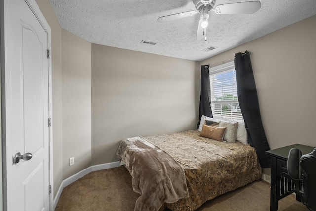 carpeted bedroom featuring a textured ceiling, visible vents, and baseboards