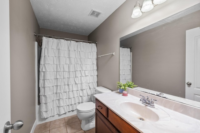 full bath with a textured ceiling, visible vents, toilet, vanity, and tile patterned flooring