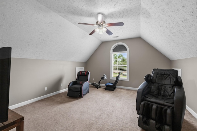sitting room with lofted ceiling, a textured ceiling, visible vents, and carpet floors