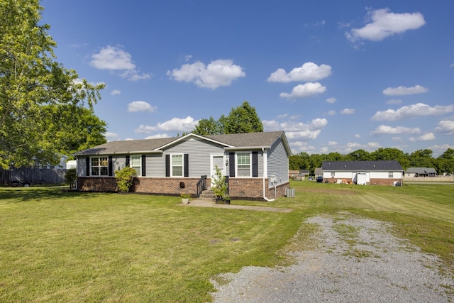 view of front of property featuring fence, a front yard, driveway, and brick siding