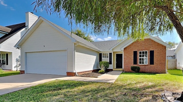 ranch-style house featuring a front yard, a garage, brick siding, driveway, and a chimney