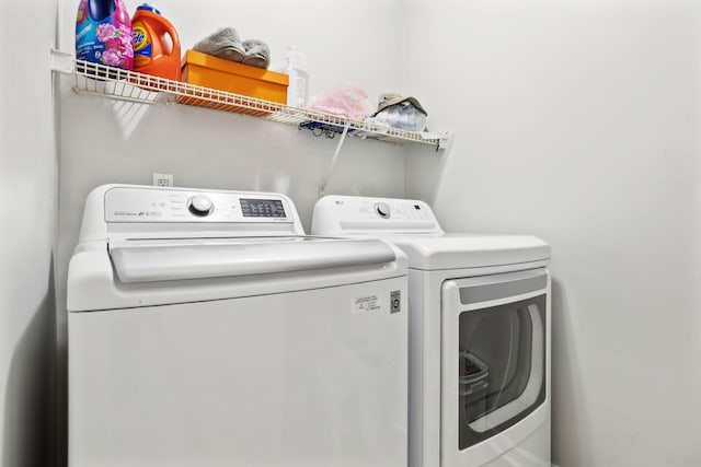 laundry area featuring washing machine and clothes dryer