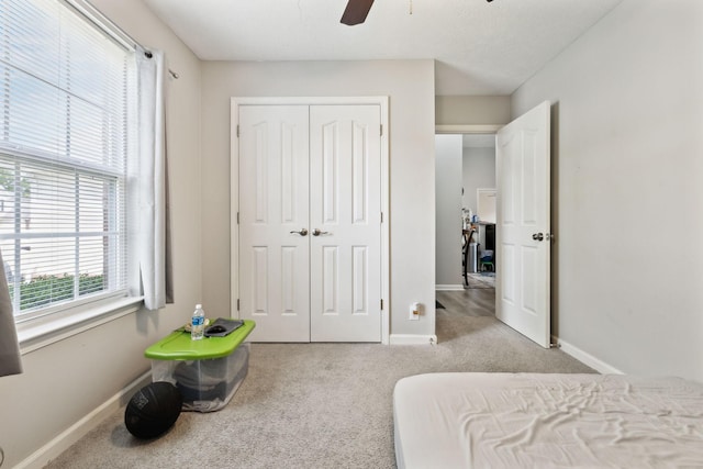 bedroom with carpet, baseboards, a closet, and ceiling fan