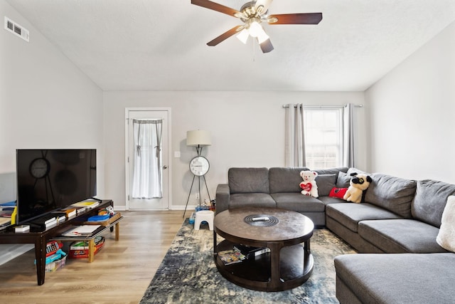 living room with ceiling fan, wood finished floors, and baseboards