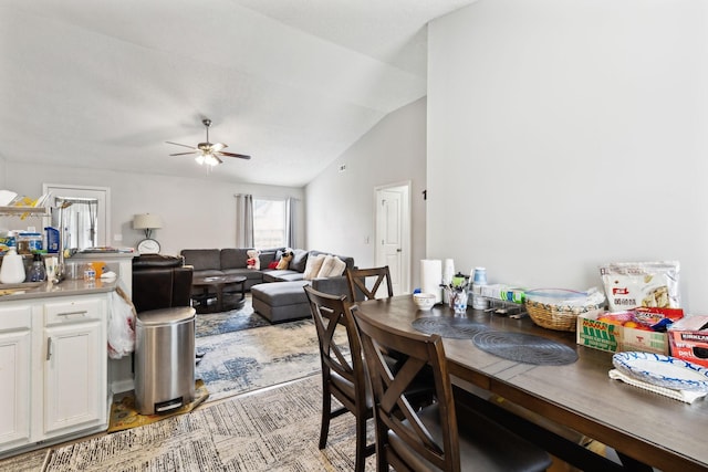 dining space featuring ceiling fan and vaulted ceiling