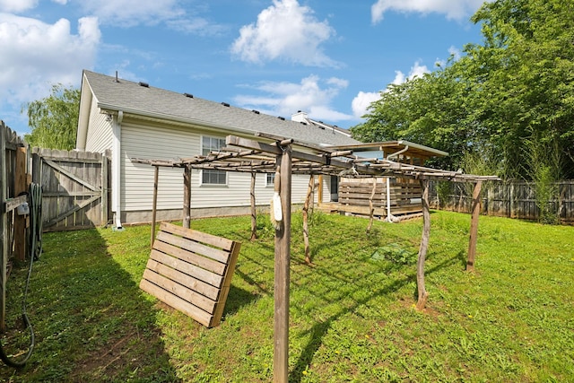 view of yard with a pergola and a gate