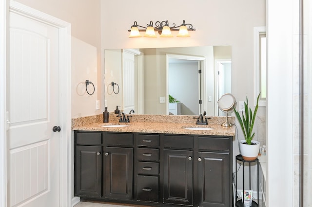 bathroom with a sink and double vanity