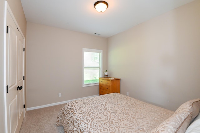 carpeted bedroom with baseboards and visible vents