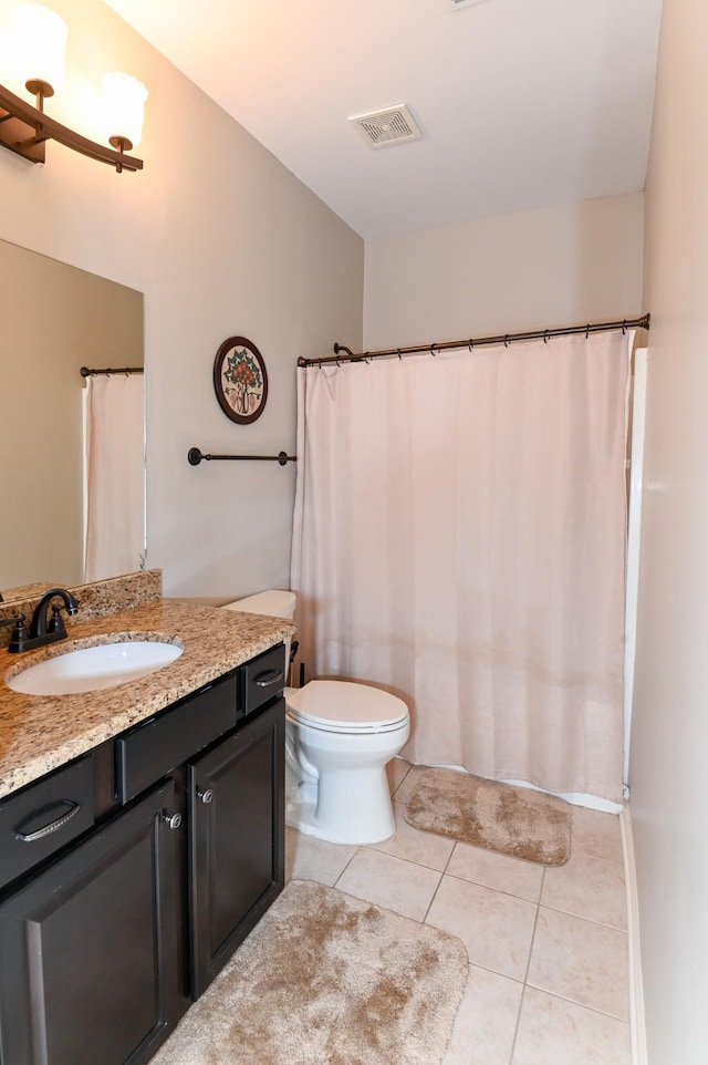 bathroom featuring visible vents, tile patterned floors, toilet, and vanity