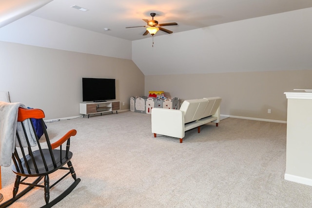 interior space with baseboards, vaulted ceiling, and light carpet