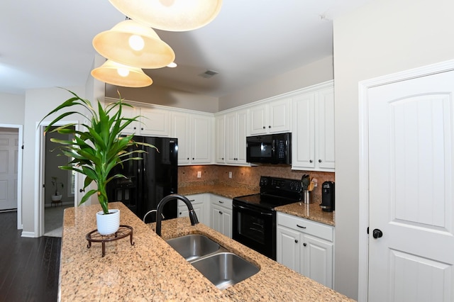 kitchen with visible vents, white cabinets, a sink, backsplash, and black appliances