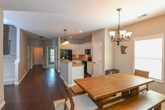 dining room featuring visible vents, baseboards, dark wood-style floors, recessed lighting, and a notable chandelier