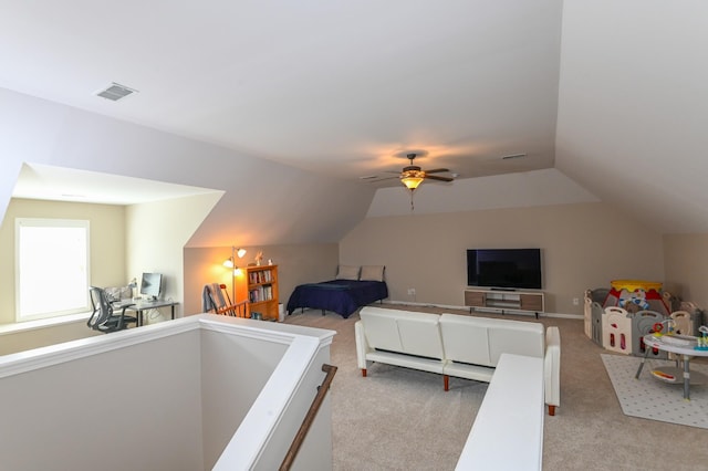 bedroom featuring ceiling fan, vaulted ceiling, light colored carpet, and visible vents