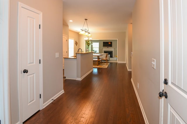 entrance foyer featuring baseboards, a fireplace, recessed lighting, and dark wood-type flooring