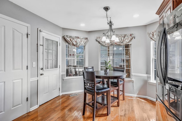 dining room featuring visible vents, baseboards, recessed lighting, light wood finished floors, and a notable chandelier