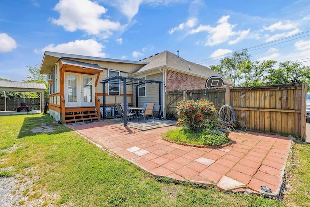 rear view of property with french doors, a lawn, a patio, a fenced backyard, and a pergola