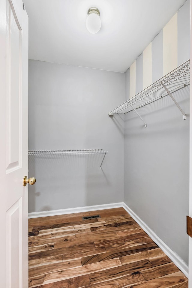spacious closet with visible vents and wood finished floors