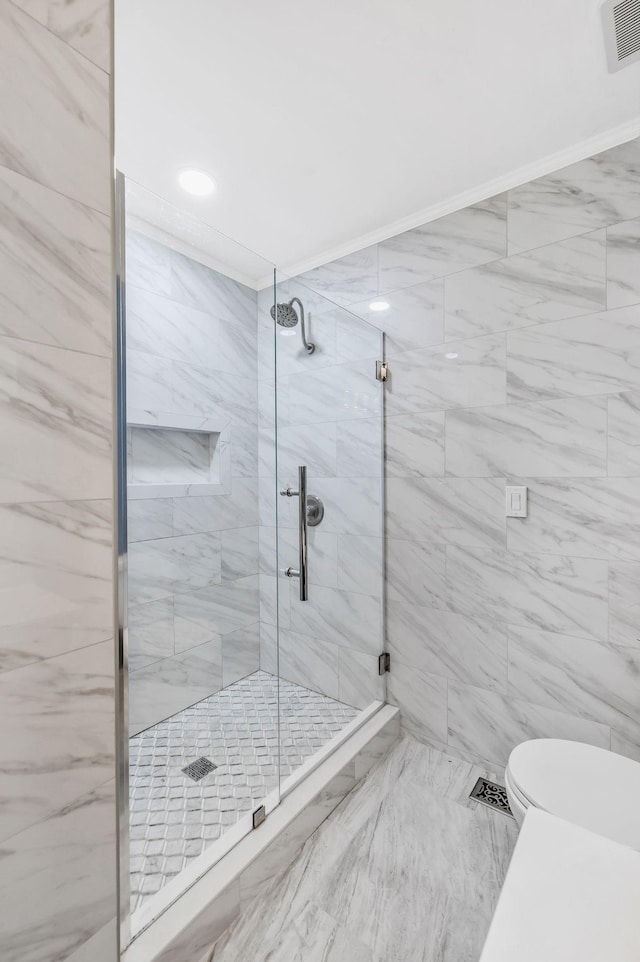 bathroom featuring visible vents, toilet, and a shower stall