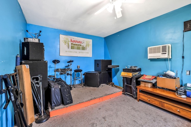 misc room with carpet, a ceiling fan, and a wall mounted air conditioner