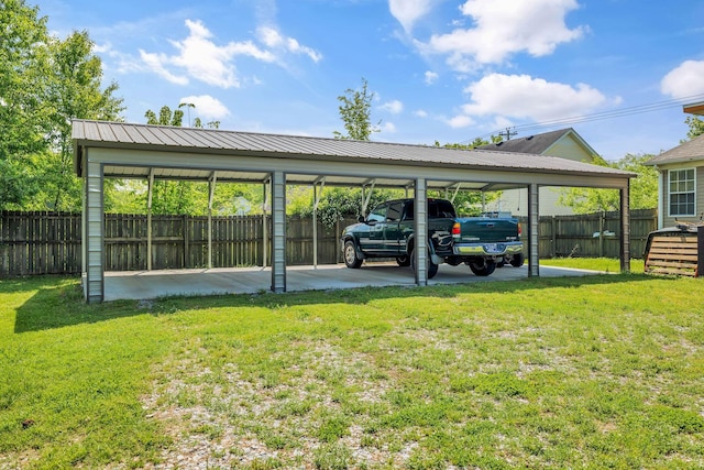 view of car parking featuring a detached carport and fence