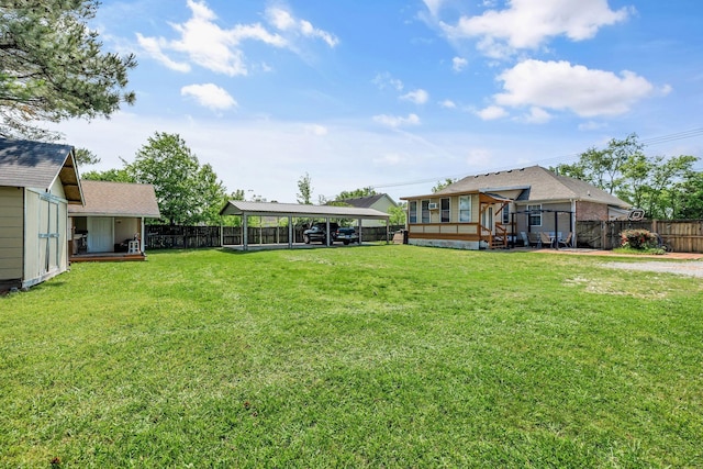 view of yard with a fenced backyard and a detached carport