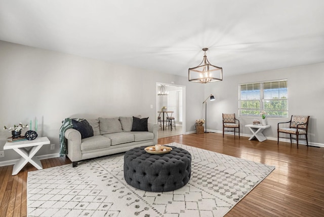 174 Hickory Ln, Jacksboro, TN 37757 - living area featuring wood finished floors, a notable chandelier, and baseboards