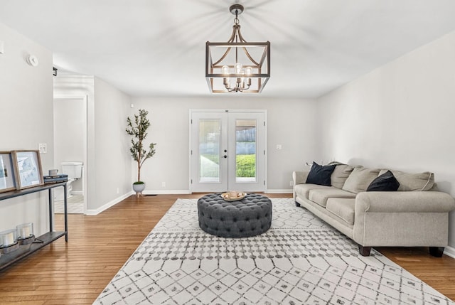 174 Hickory Ln, Jacksboro, TN 37757 - living room with french doors, a chandelier, wood finished floors, and baseboards