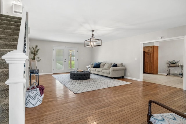 174 Hickory Ln, Jacksboro, TN 37757 - living room featuring a notable chandelier, stairs, and light wood-style flooring
