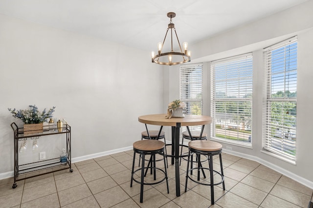 174 Hickory Ln, Jacksboro, TN 37757 - dining space with light tile patterned floors, a wealth of natural light, a chandelier, and baseboards