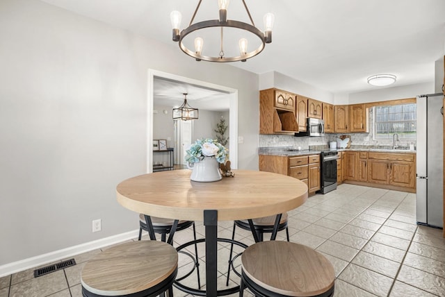 174 Hickory Ln, Jacksboro, TN 37757 - kitchen with a sink, stainless steel appliances, a chandelier, light tile patterned floors, and visible vents