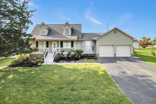 174 Hickory Ln, Jacksboro, TN 37757 - cape cod home featuring aphalt driveway, a front yard, fence, a porch, and a garage