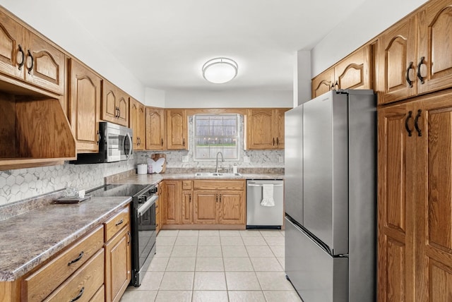 174 Hickory Ln, Jacksboro, TN 37757 - kitchen featuring light tile patterned floors, brown cabinets, decorative backsplash, a sink, and appliances with stainless steel finishes
