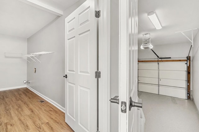 174 Hickory Ln, Jacksboro, TN 37757 - laundry area with a garage, wood finished floors, and baseboards