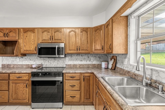 174 Hickory Ln, Jacksboro, TN 37757 - kitchen featuring stainless steel microwave, a sink, brown cabinetry, and black range with electric cooktop