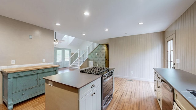 1344 French Brantley Rd, Wartrace, TN 37183 - kitchen featuring appliances with stainless steel finishes, light wood-type flooring, butcher block counters, a kitchen island, and baseboards