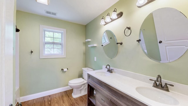 1344 French Brantley Rd, Wartrace, TN 37183 - full bath featuring toilet, baseboards, wood finished floors, double vanity, and a tub to relax in