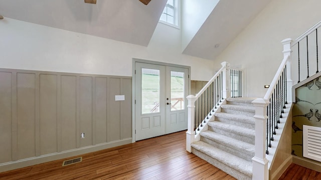 1344 French Brantley Rd, Wartrace, TN 37183 - entryway with stairway, hardwood / wood-style flooring, a towering ceiling, wainscoting, and french doors