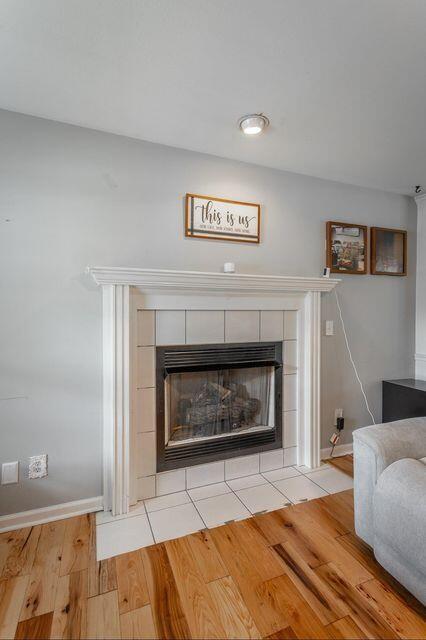 8424 Shadetree Ln, Ooltewah, TN 37363 - detailed view of a fireplace, wood finished floors, and baseboards